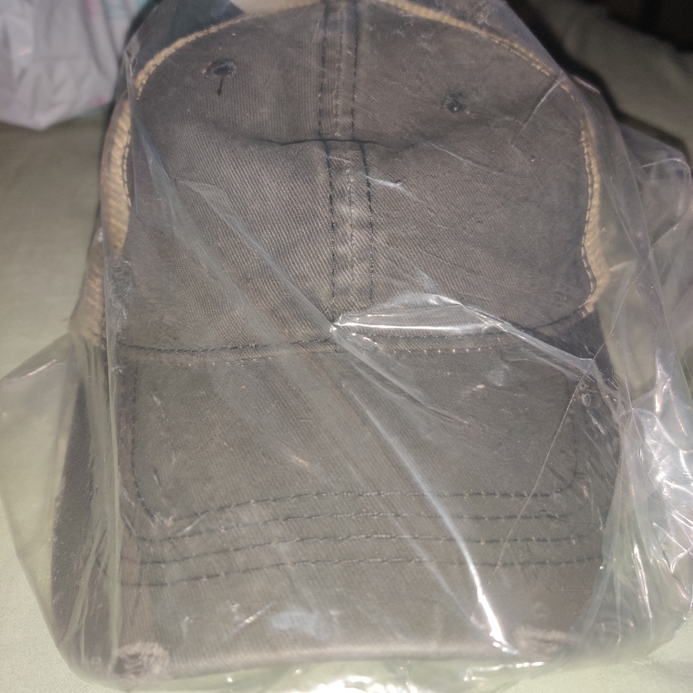 Women's distressed criss cross ponytail trucker hat